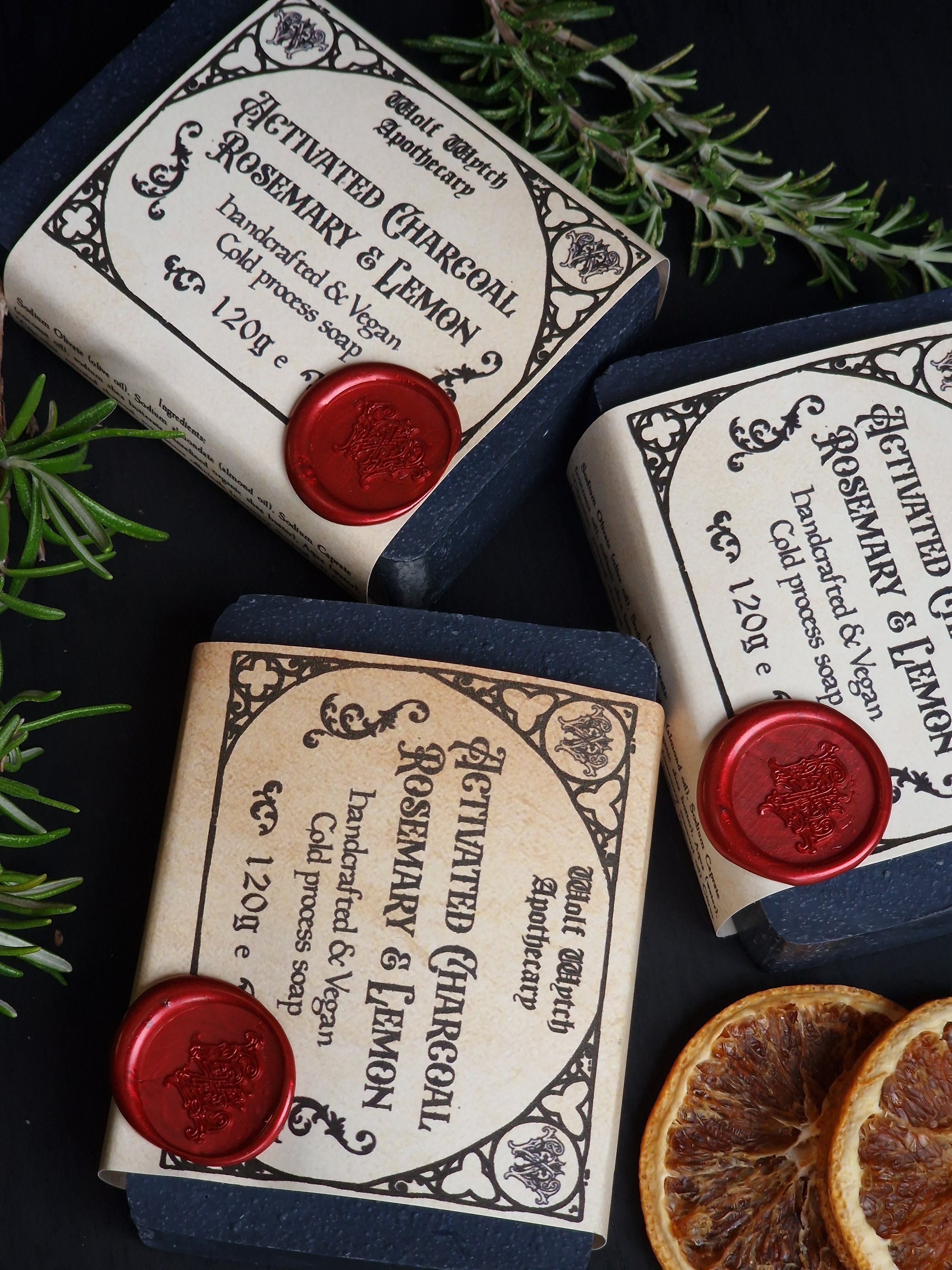Three bars of soap with labels on a dark background